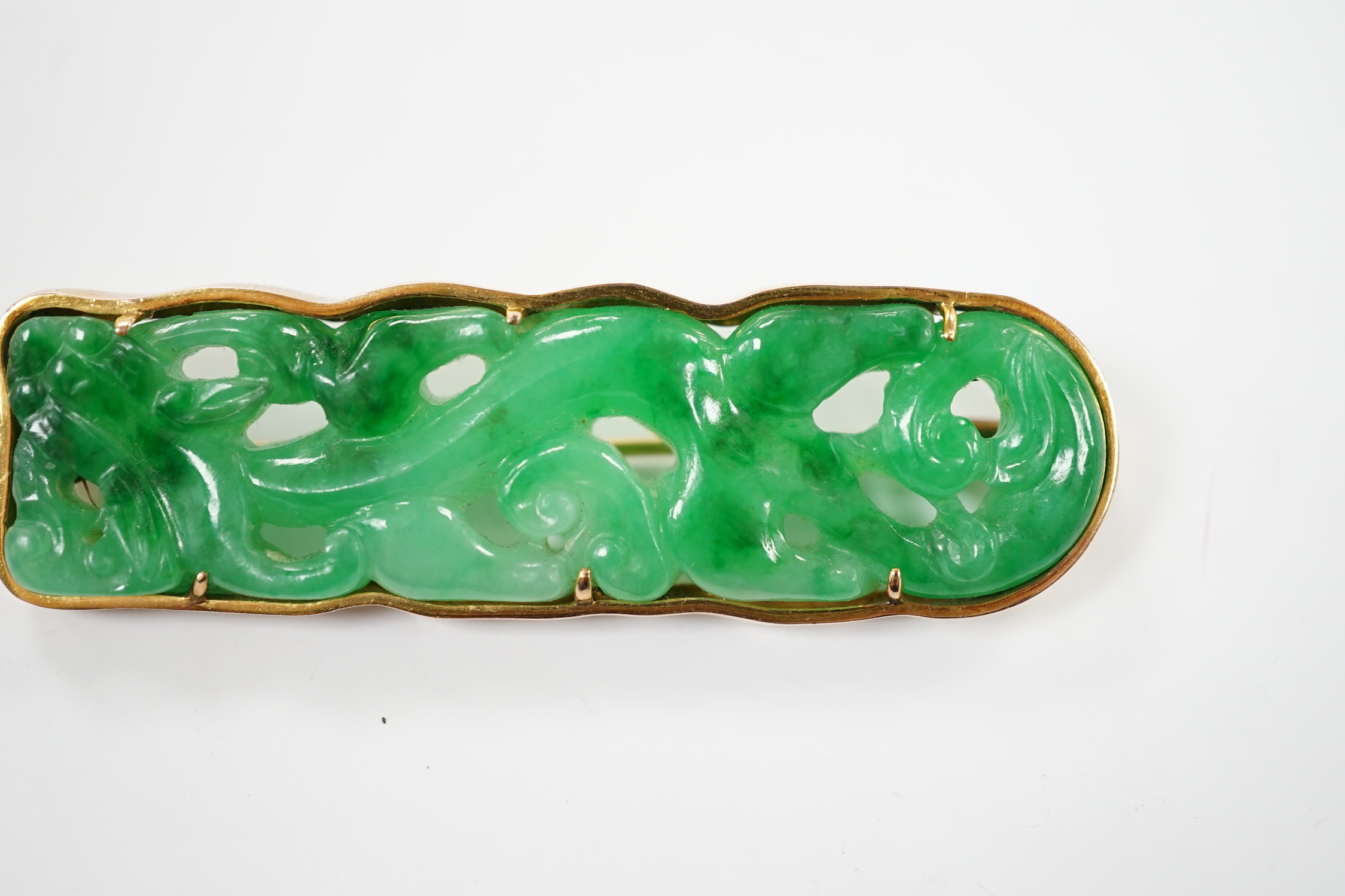 A Chinese 14k yellow metal and carved jade set rounded rectangular brooch, 63mm